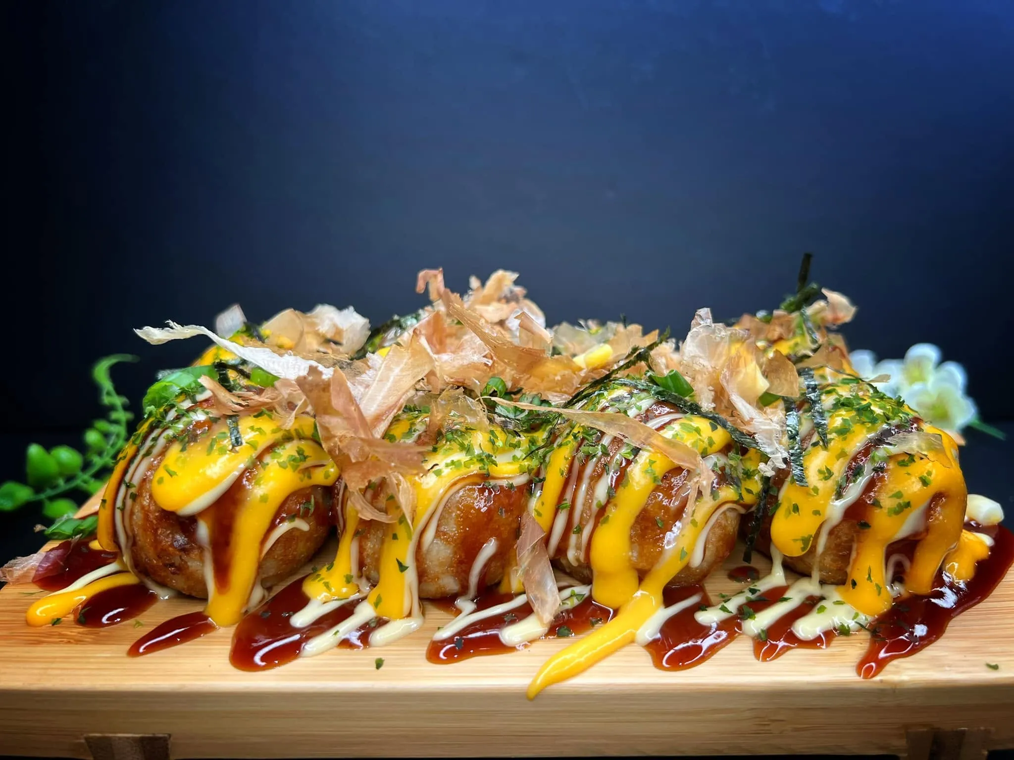 Cheesy takoyaki with takoyaki sauce, Japanese mayo and bonito flakes in Calgary NE